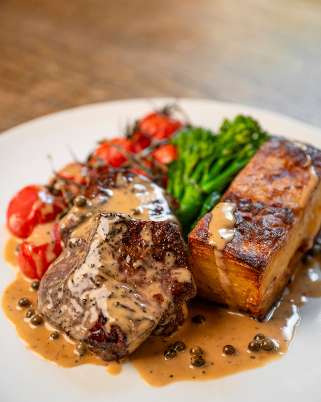 Seared beef fillet with peppercorn sauce and crispy fondant potato at The Three Horseshoes Inn, Lickfold.