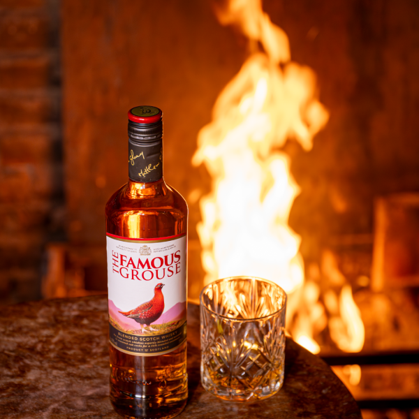 A dram of whisky beside a crackling log fire at The Three Horseshoes Inn, Lickfold, near Petworth and Midhurst